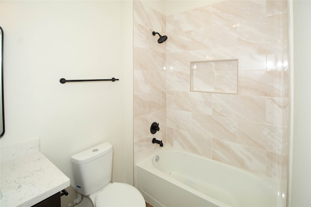 full bathroom featuring toilet, vanity, and tiled shower / bath