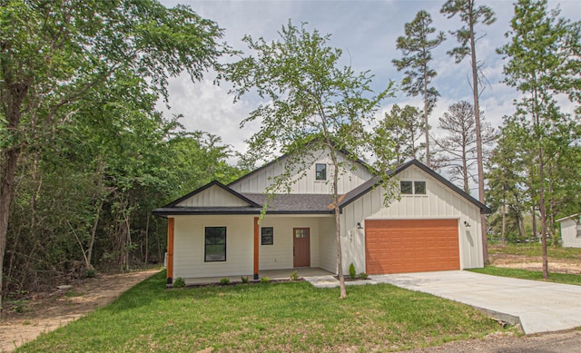 modern inspired farmhouse with a front lawn and a garage