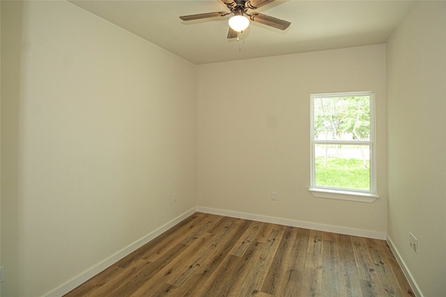 spare room with dark hardwood / wood-style floors and ceiling fan