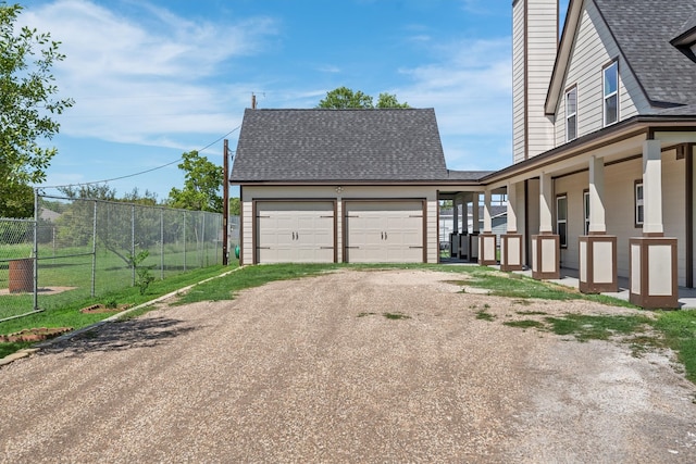 exterior space featuring covered porch and a garage