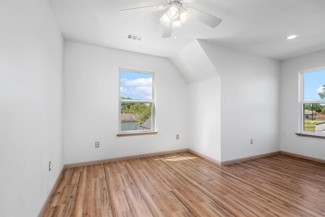 interior space with ceiling fan, vaulted ceiling, and light wood-type flooring