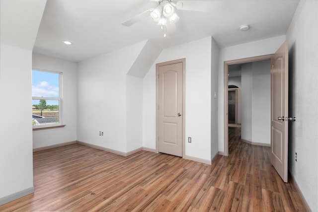 bonus room with ceiling fan and hardwood / wood-style flooring