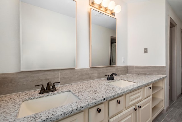 bathroom with backsplash, oversized vanity, tile floors, and dual sinks