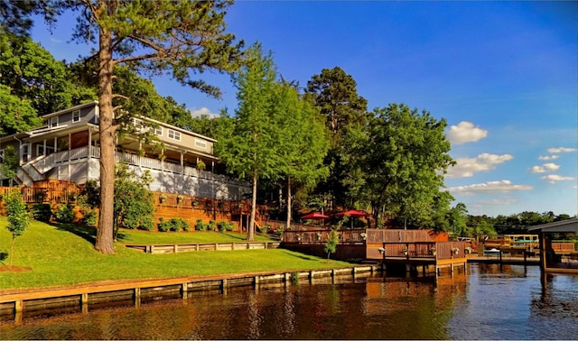 dock area with a water view and a lawn