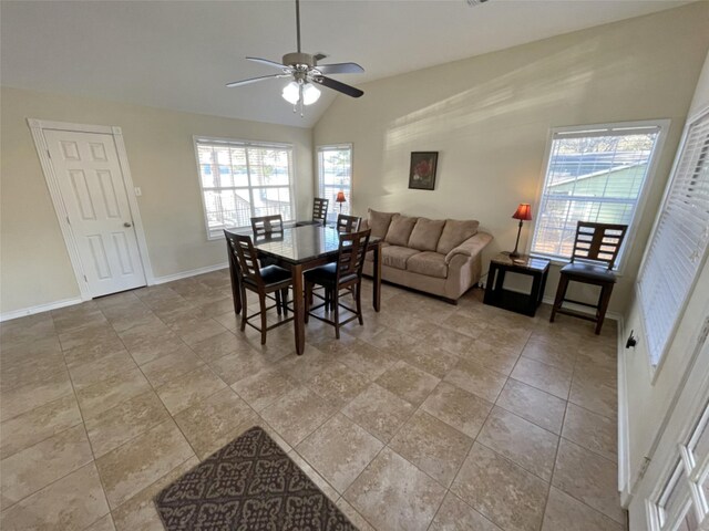 tiled dining room with plenty of natural light, lofted ceiling, and ceiling fan