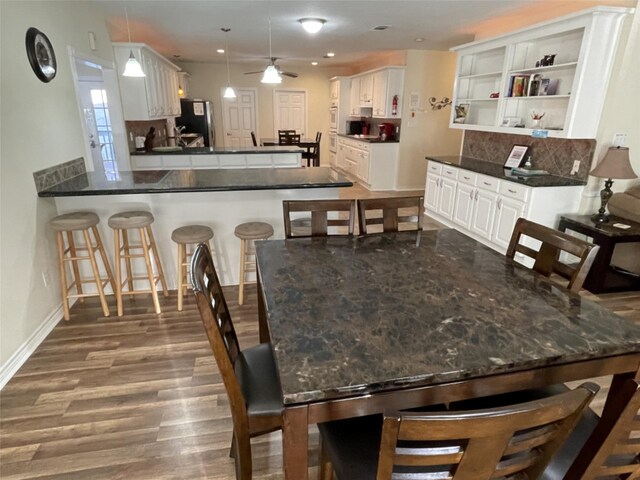 dining area featuring ceiling fan and hardwood / wood-style flooring