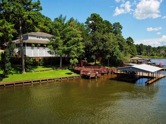 view of dock featuring a water view and a lawn