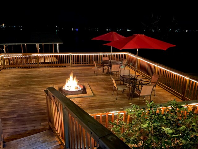 deck at night with an outdoor fire pit
