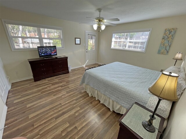 bedroom with ceiling fan and dark hardwood / wood-style floors