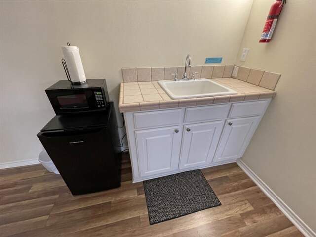bathroom with hardwood / wood-style floors and sink