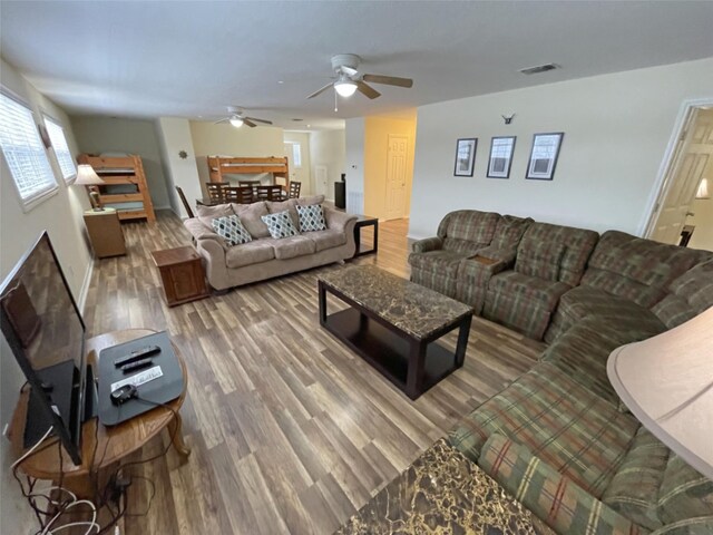 living room featuring ceiling fan and hardwood / wood-style floors