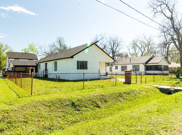 rear view of property with a lawn