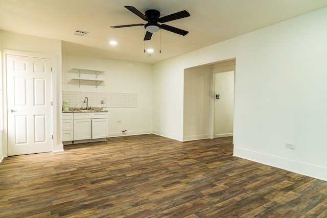 empty room featuring sink, ceiling fan, and dark hardwood / wood-style flooring