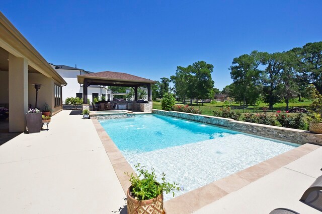 view of swimming pool with pool water feature, a gazebo, and a patio