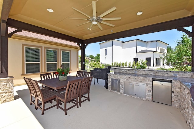 view of patio / terrace featuring exterior kitchen and ceiling fan