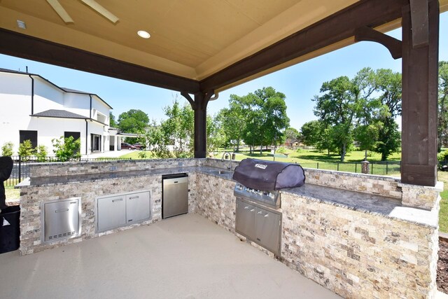 view of patio / terrace featuring a grill and an outdoor kitchen