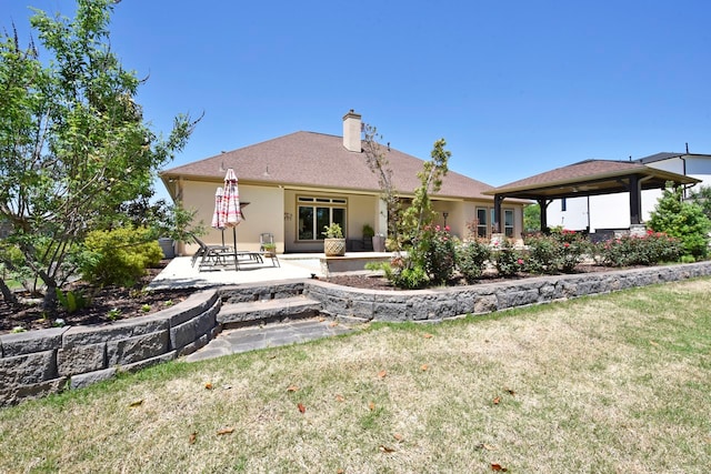 rear view of house featuring a patio and a lawn