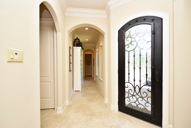 foyer featuring ornamental molding and light tile floors