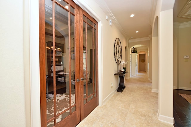 hallway with crown molding and light tile floors