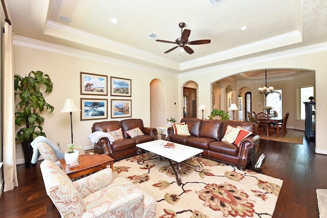 living room featuring ornamental molding, dark hardwood / wood-style flooring, and a raised ceiling