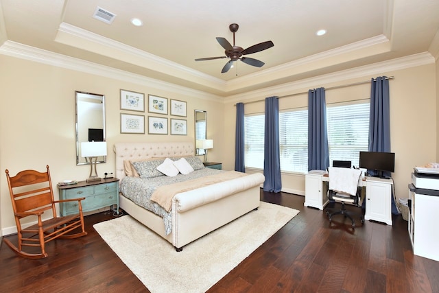 bedroom with ornamental molding, ceiling fan, a tray ceiling, and dark hardwood / wood-style floors