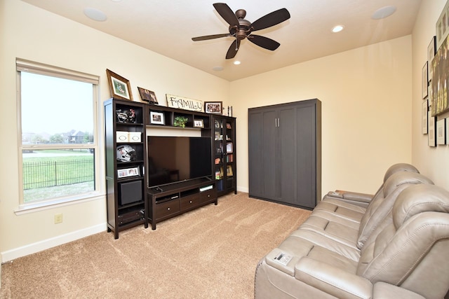 carpeted living room featuring ceiling fan