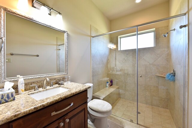 bathroom featuring walk in shower, vanity, and toilet