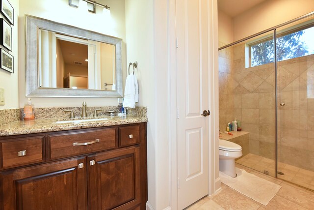 bathroom featuring walk in shower, toilet, tile floors, and vanity