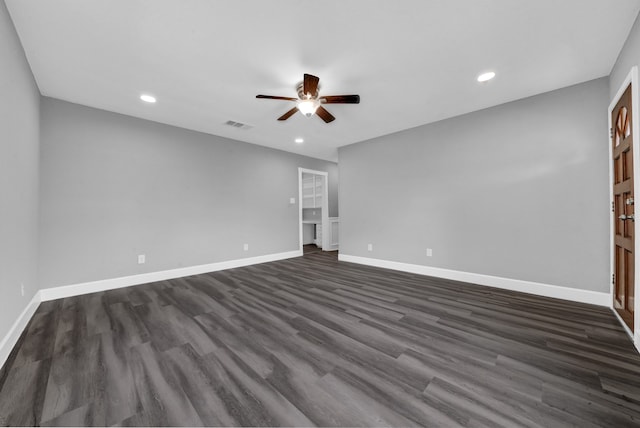 spare room featuring ceiling fan and dark wood-type flooring