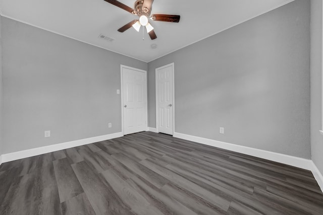 unfurnished room with dark hardwood / wood-style flooring and ceiling fan