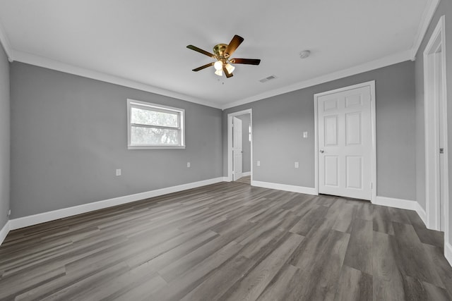 unfurnished room with ornamental molding, dark hardwood / wood-style flooring, and ceiling fan