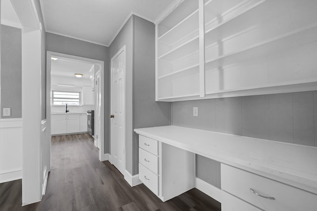 corridor featuring ornamental molding and dark hardwood / wood-style flooring