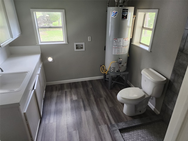 bathroom with gas water heater, a healthy amount of sunlight, vanity, and wood-type flooring