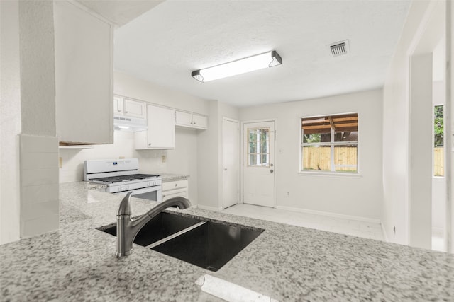 kitchen featuring white cabinets, light stone countertops, white range with gas cooktop, and sink