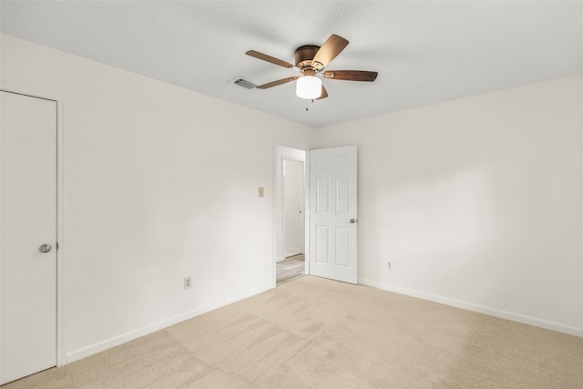 carpeted empty room with ceiling fan