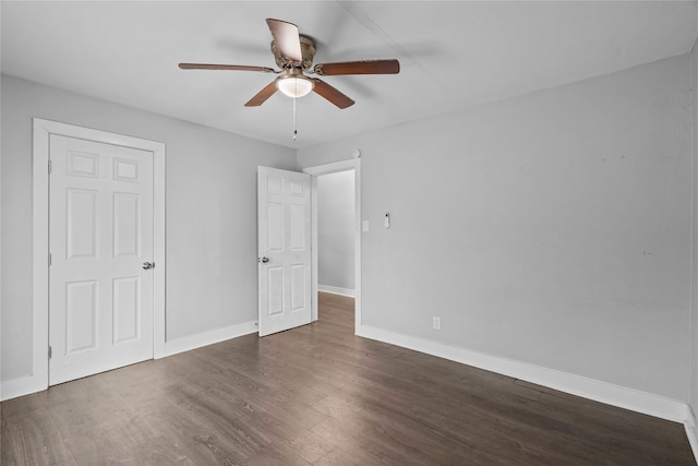 unfurnished bedroom featuring ceiling fan and dark hardwood / wood-style floors