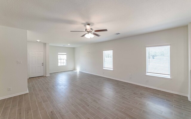 spare room featuring ceiling fan, a textured ceiling, and light hardwood / wood-style floors