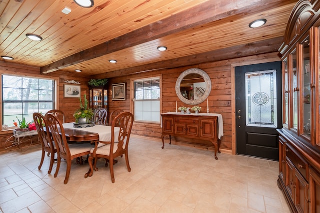 dining room featuring beam ceiling, wooden ceiling, light tile floors, and a wealth of natural light