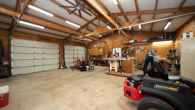 garage with a workshop area and ceiling fan