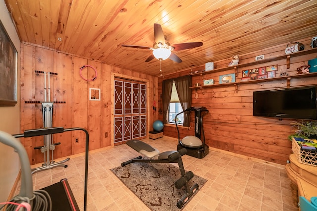 exercise room featuring wooden ceiling, light tile flooring, and ceiling fan