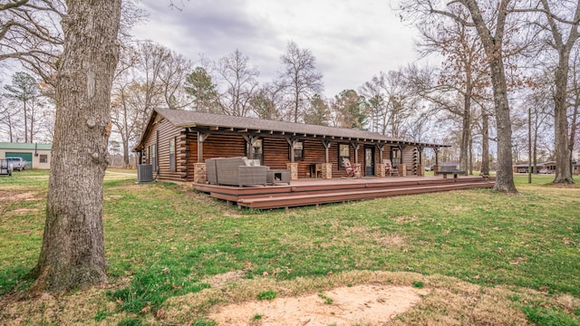 rear view of house with a deck and a lawn