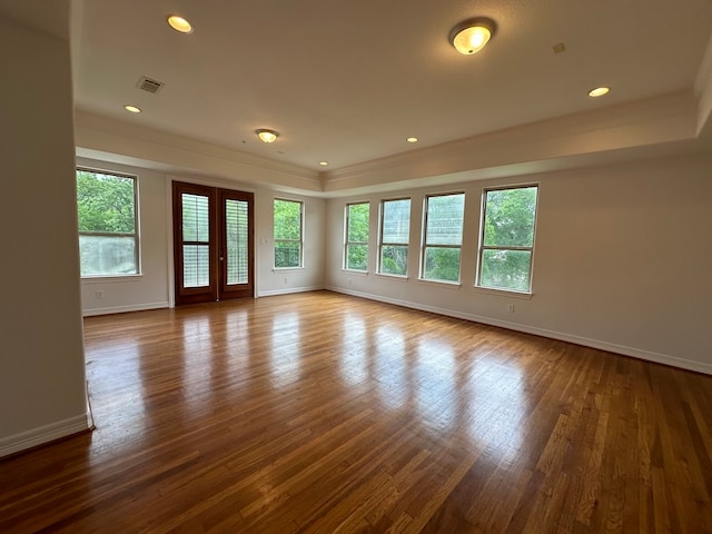 empty room featuring french doors and dark hardwood / wood-style flooring