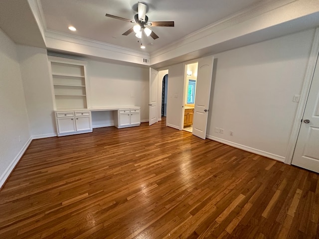 unfurnished bedroom featuring ceiling fan, dark wood-type flooring, and crown molding