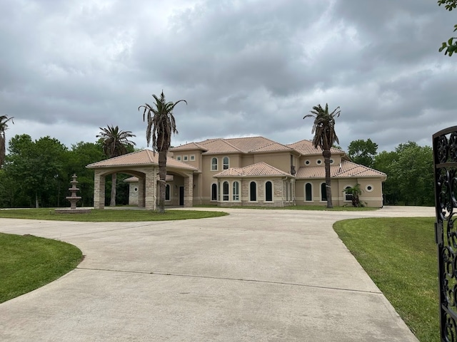 mediterranean / spanish-style house featuring a front yard