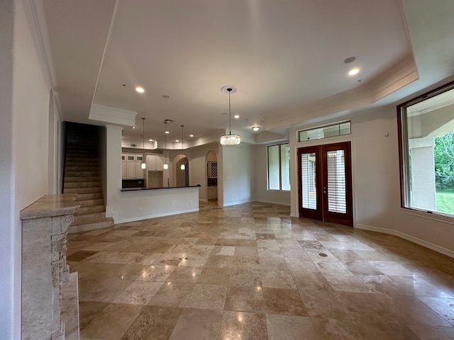 unfurnished living room featuring light tile floors, french doors, and crown molding