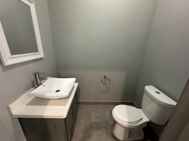 bathroom featuring toilet, vanity, and wood-type flooring