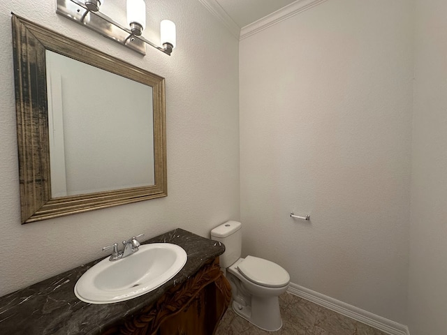 bathroom featuring toilet, tile flooring, vanity, and crown molding