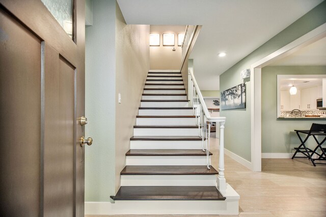 staircase with light wood-type flooring