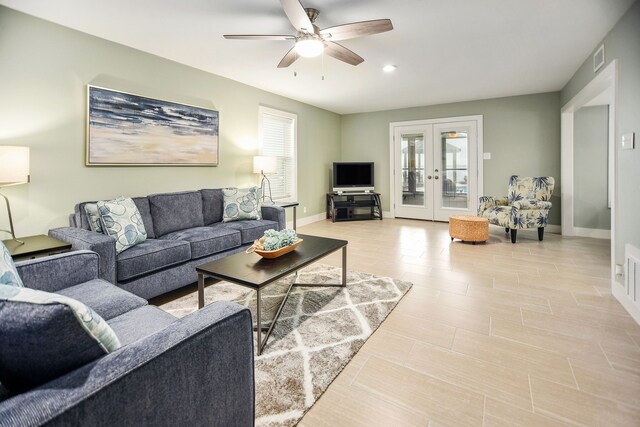 living room featuring ceiling fan and french doors