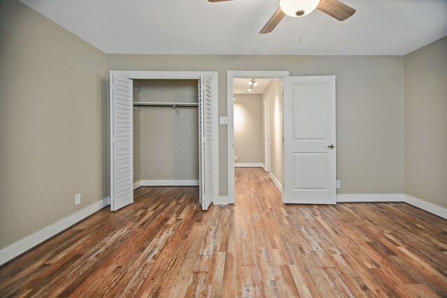 unfurnished bedroom with ceiling fan and dark hardwood / wood-style flooring